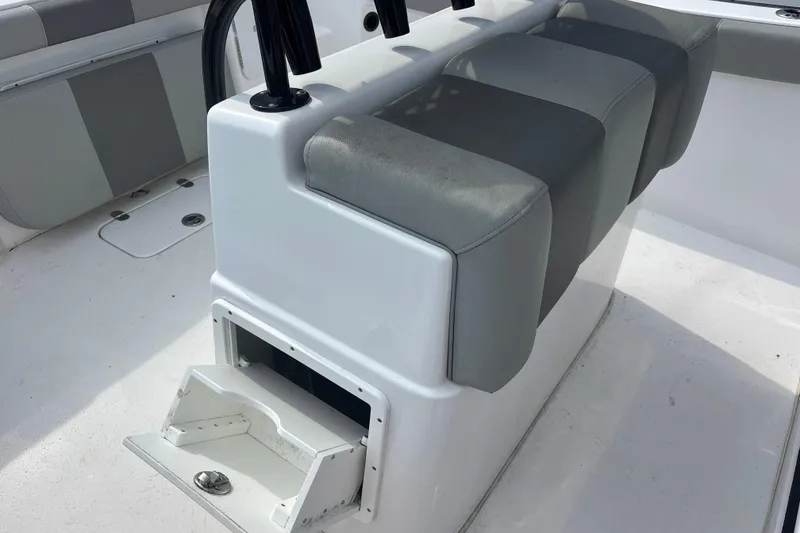 Slide: The Image of 2022 Cape Horn 22 OS boat interior with cushioned seating and storage compartment. - 63