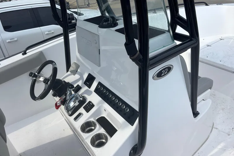 Slide: The Image of 2022 Cape Horn 22 OS boat console with steering wheel and controls. - 65