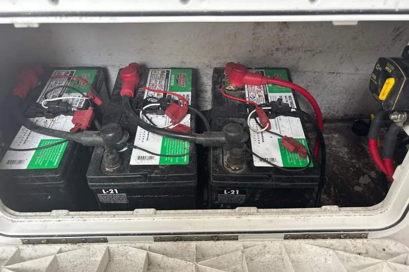 Slide: The Image of Three marine batteries in a 2022 Cape Horn 22 OS boat compartment. - 74