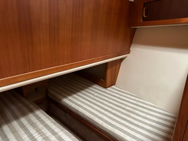 Slide: The Image of Aft cabin with striped bedding in 2000 Mainship 43 Trawler. - 13