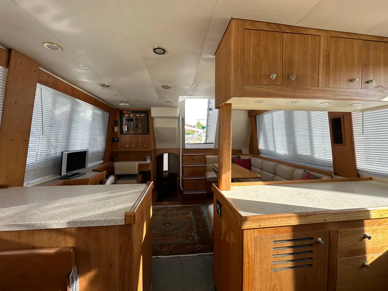 Slide: The Image of Interior of 2000 Mainship 43 Trawler Aft Cabin with wood finish and modern amenities. - 19