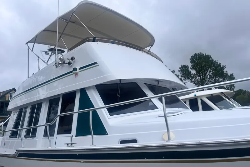 Slide: The Image of 2000 Mainship 43 Trawler Aft Cabin with white exterior and green accents. - 2