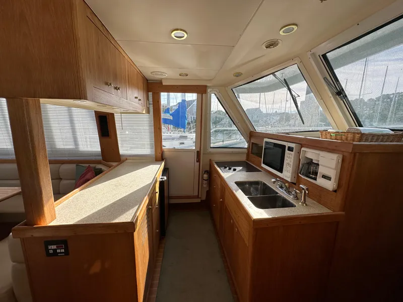 Slide: The Image of Interior of 2000 Mainship 43 Trawler Aft Cabin with kitchen and seating area. - 23