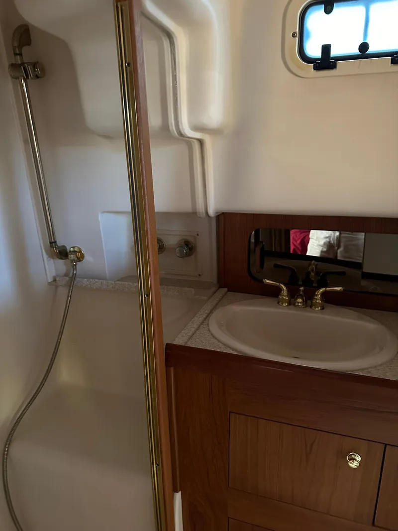Slide: The Image of 2000 Mainship 43 Trawler Aft Cabin bathroom with shower and sink. - 25