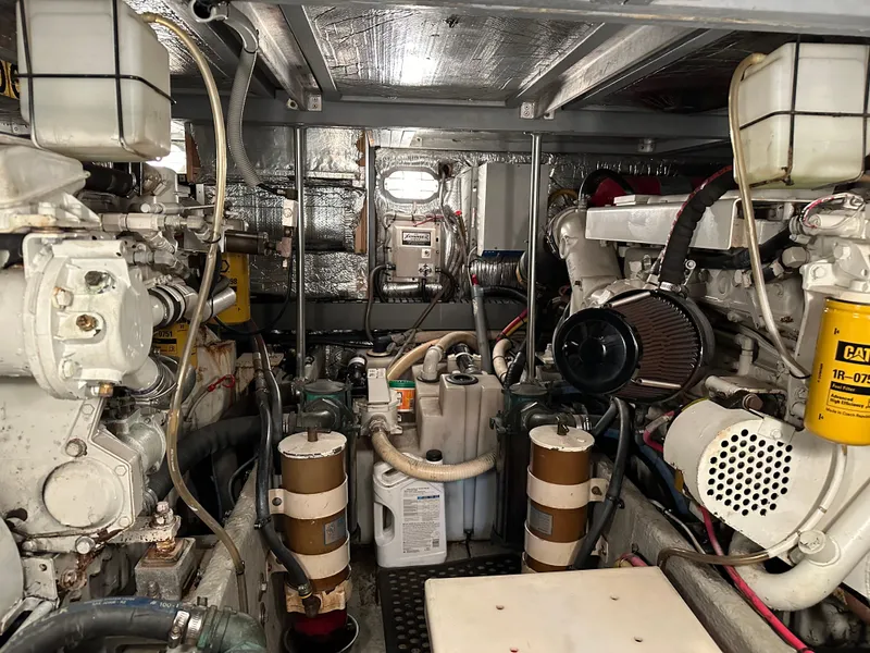 Slide: The Image of Engine room of 2000 Mainship 43 Trawler Aft Cabin with visible machinery and components. - 26