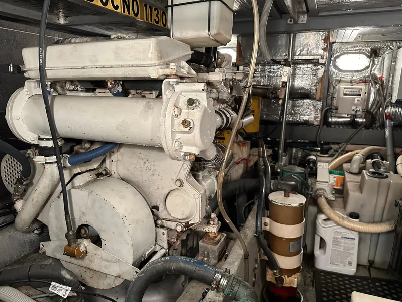 Slide: The Image of Engine room of 2000 Mainship 43 Trawler Aft Cabin with visible machinery and equipment. - 28