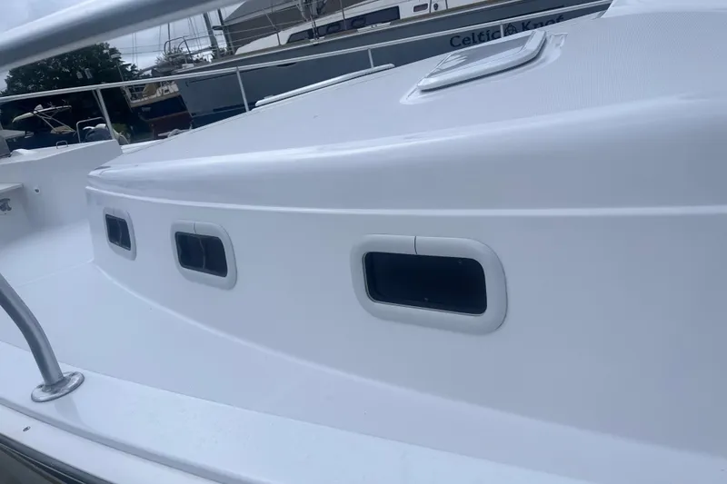 Slide: The Image of 2000 Mainship 43 Trawler Aft Cabin, white exterior with windows, docked at marina. - 29