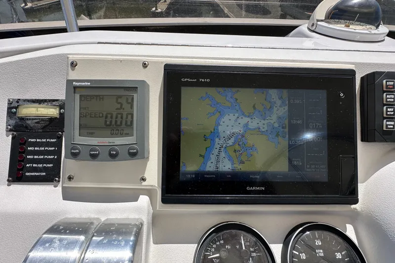 Slide: The Image of Control panel of a 2000 Mainship 43 Trawler Aft Cabin with navigation displays. - 32