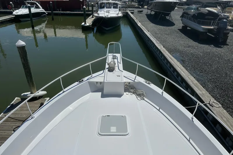 Slide: The Image of Bow view of 2000 Mainship 43 Trawler Aft Cabin docked at marina. - 34