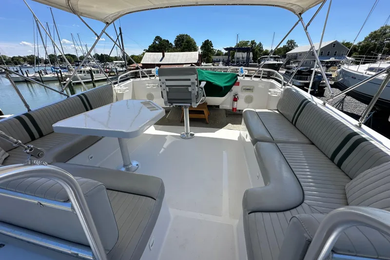 Slide: The Image of 2000 Mainship 43 Trawler Aft Cabin with spacious seating and table on deck. - 37