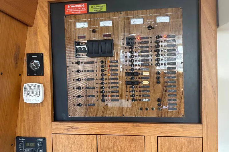 Slide: The Image of Electrical control panel on 2000 Mainship 43 Trawler Aft Cabin, featuring switches and indicators. - 38