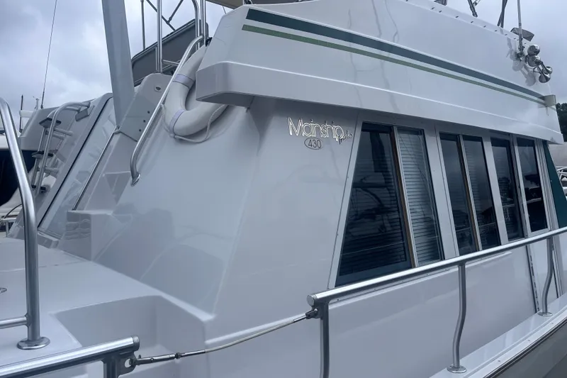 Slide: The Image of 2000 Mainship 43 Trawler Aft Cabin with sleek design and large windows. - 4