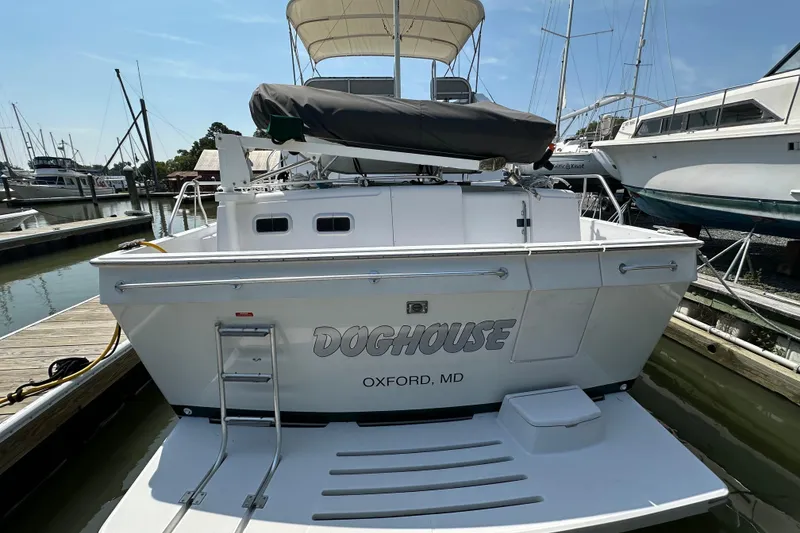 Slide: The Image of 2000 Mainship 43 Trawler Aft Cabin docked, featuring "Doghouse" name, Oxford, MD. - 6