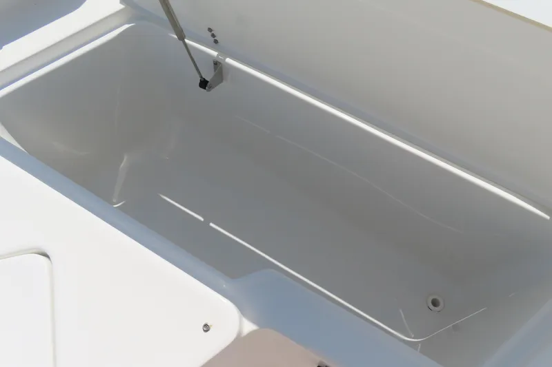 Slide: The Image of 2019 Sea Hunt Ultra 225 boat storage compartment, open and empty. - 11