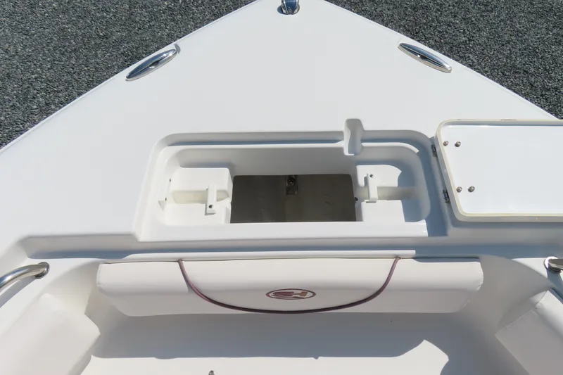 Slide: The Image of 2019 Sea Hunt Ultra 225 boat bow with storage compartment and seating. - 13