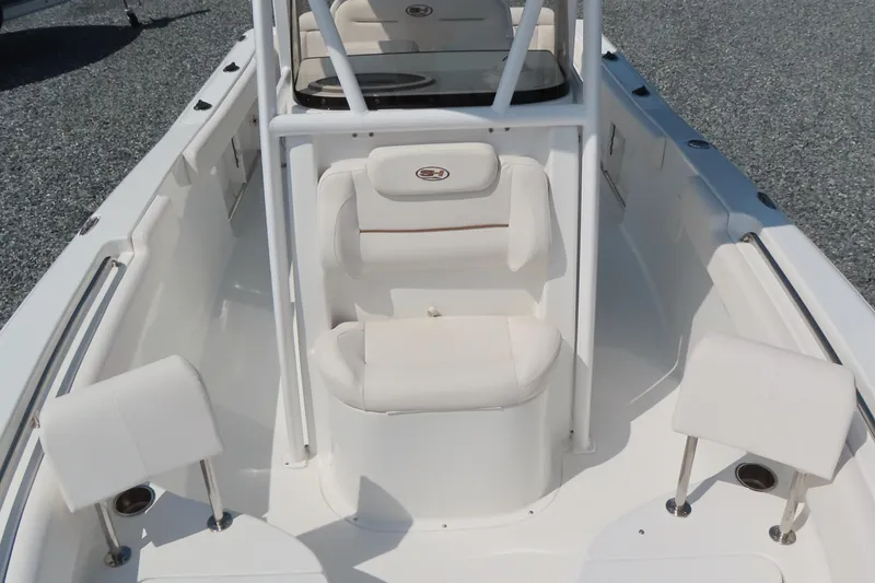 Slide: The Image of 2019 Sea Hunt Ultra 225 boat interior with white seating and console. - 14