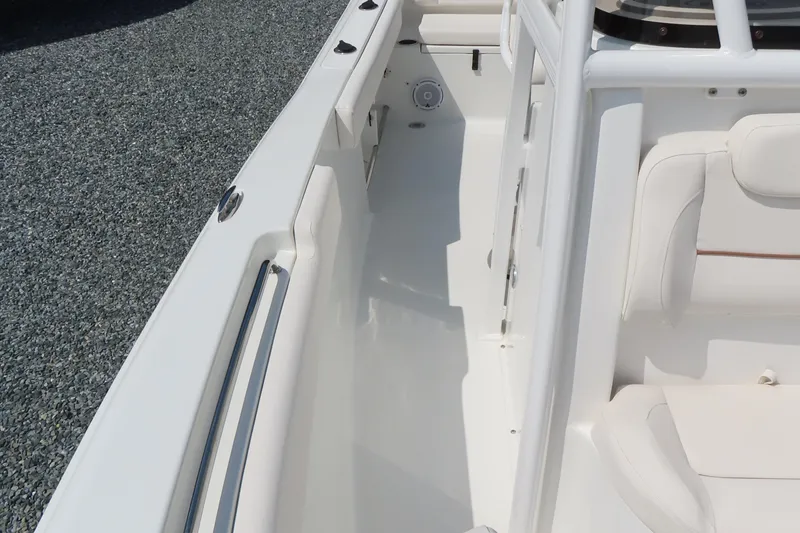 Slide: The Image of 2019 Sea Hunt Ultra 225 boat interior with white seating and sleek design. - 15