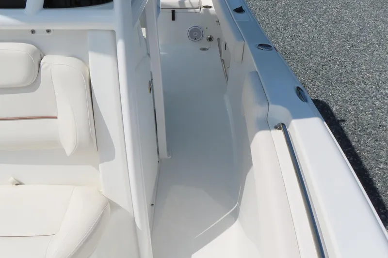 Slide: The Image of 2019 Sea Hunt Ultra 225 boat interior with white seating and sleek design. - 16