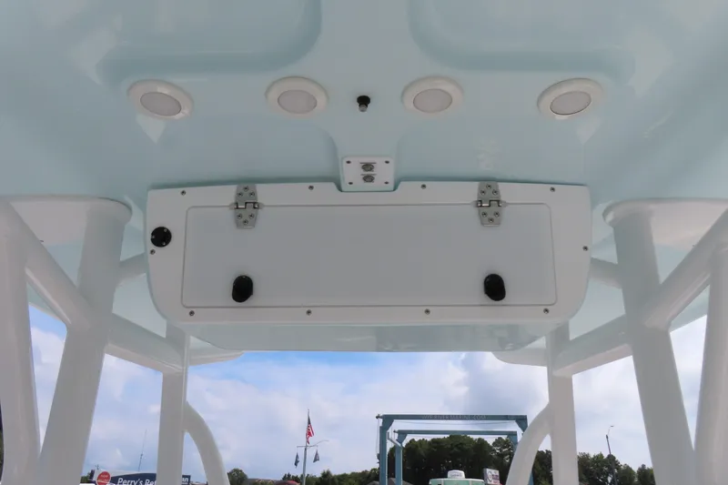 Slide: The Image of 2019 Sea Hunt Ultra 225 boat interior ceiling with storage compartment and lights. - 24