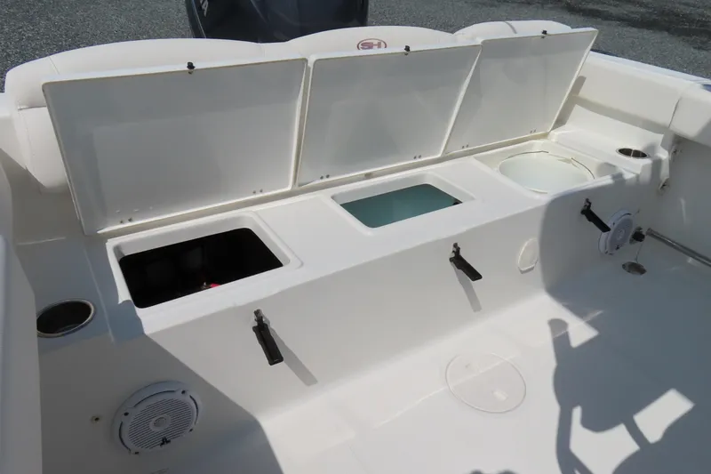 Slide: The Image of 2019 Sea Hunt Ultra 225 boat storage compartments and seating area. - 31