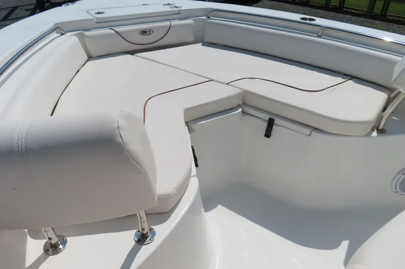 Slide: The Image of 2019 Sea Hunt Ultra 225 boat interior with white cushioned seating. - 7