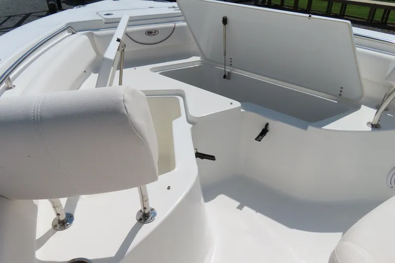 Slide: The Image of 2019 Sea Hunt Ultra 225 boat interior with open storage compartments and seating. - 9