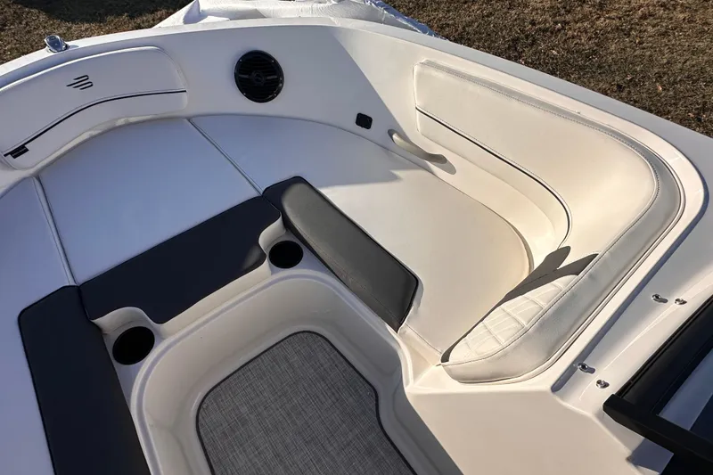 Slide: The Image of 2025 Bayliner VR5 Bowrider OB interior with white cushioned seating and cup holders. - 16