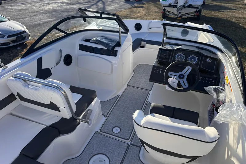 Slide: The Image of 2025 Bayliner VR5 Bowrider OB interior with modern seating and steering console. - 8
