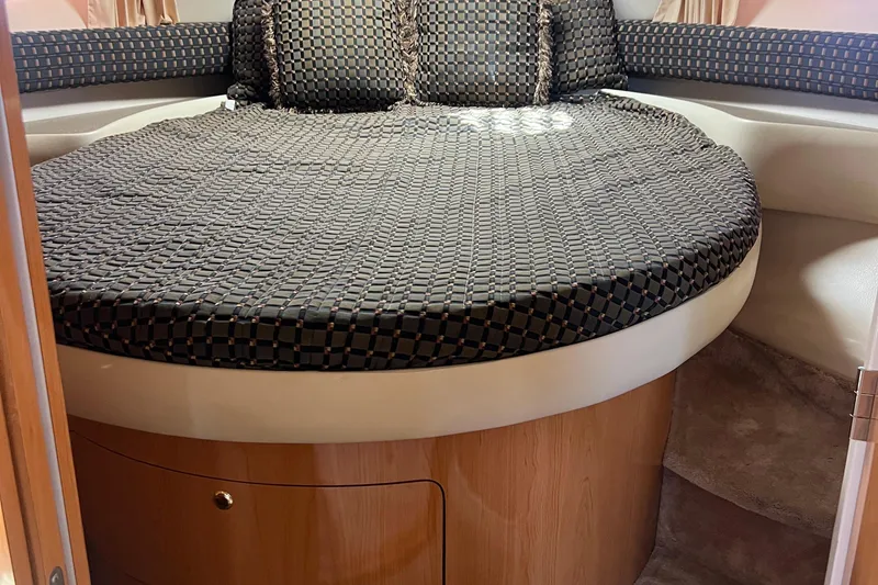 Slide: The Image of Cozy cabin interior of 2000 Regal Commodore 4160 with patterned bedding. - 21