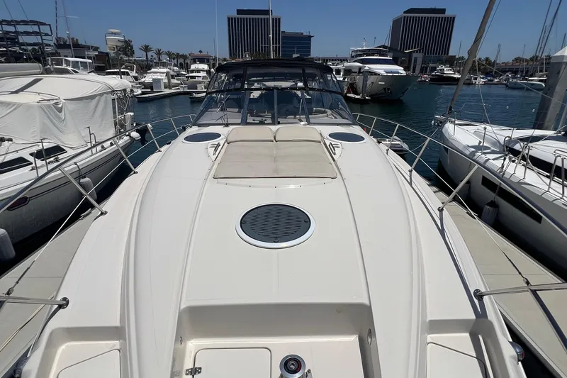 Slide: The Image of 2000 Regal Commodore 4160 yacht docked in a marina, surrounded by other boats. - 4