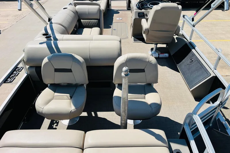 Slide: The Image of 2022 Sun Tracker SportFish 22 XP3 interior with beige seating and steering console. - 10