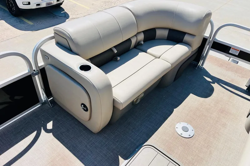 Slide: The Image of 2022 Sun Tracker SportFish 22 XP3 pontoon boat with beige seating and cup holder. - 12