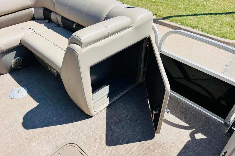 Slide: The Image of 2022 Sun Tracker SportFish 22 XP3 boat interior with open storage compartment. - 22