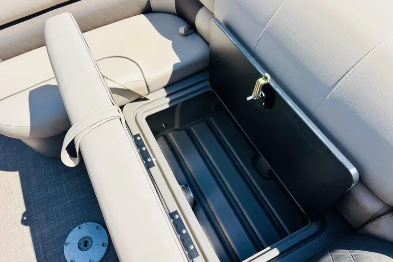 Slide: The Image of 2022 Sun Tracker SportFish 22 XP3 boat seat storage compartment open. - 25