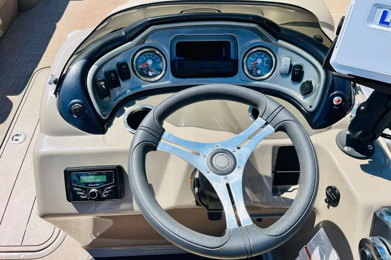 Slide: The Image of Steering console of 2022 Sun Tracker SportFish 22 XP3 boat with gauges and controls. - 29