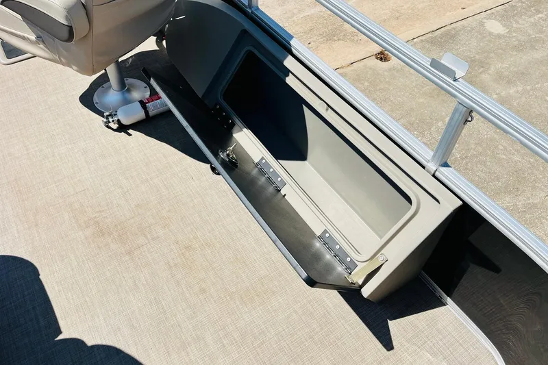 Slide: The Image of 2022 Sun Tracker SportFish 22 XP3 boat interior storage compartment with open lid. - 34