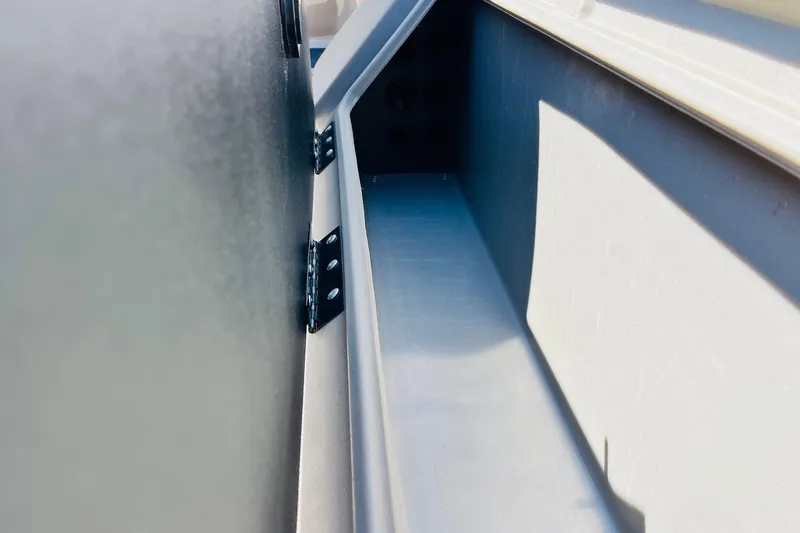 Slide: The Image of 2022 Sun Tracker SportFish 22 XP3 boat interior detail with metal hinges. - 35