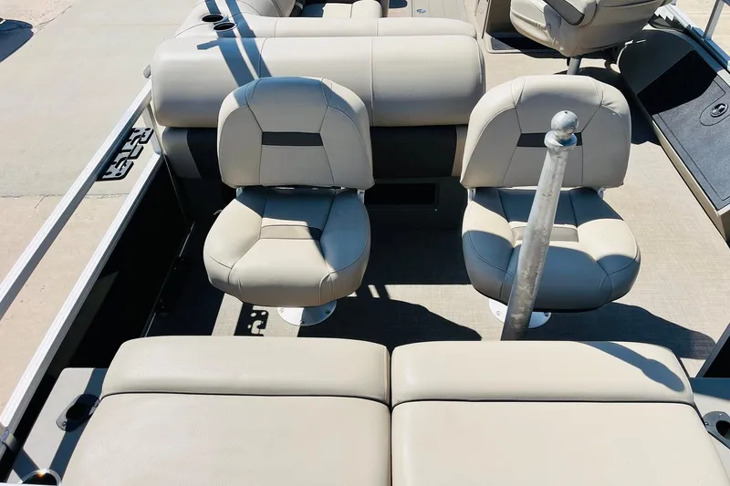Slide: The Image of 2022 Sun Tracker SportFish 22 XP3 boat interior with beige seating and fishing rod holder. - 38