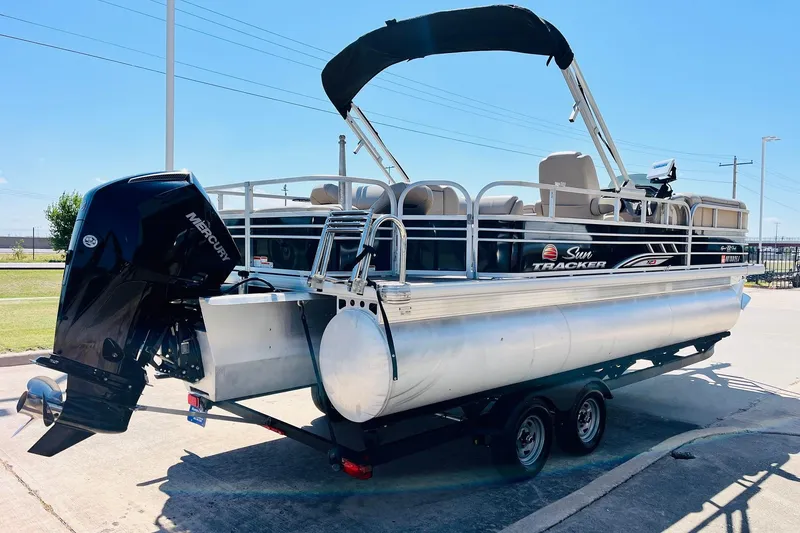 Slide: The Image of 2022 Sun Tracker SportFish 22 XP3 pontoon boat with Mercury outboard engine on trailer. - 6