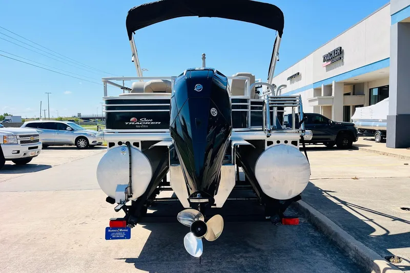 Slide: The Image of 2022 Sun Tracker SportFish 22 XP3 pontoon boat with outboard motor, parked outdoors. - 7