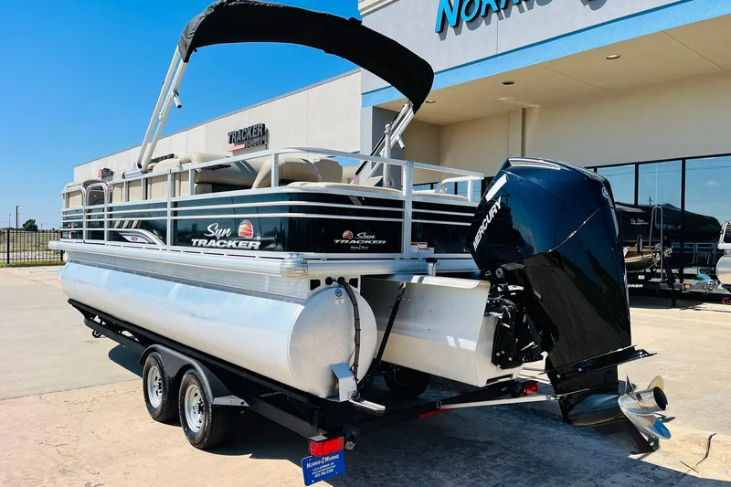 Slide: The Image of 2022 Sun Tracker SportFish 22 XP3 pontoon boat with Mercury engine, parked outside dealership. - 8