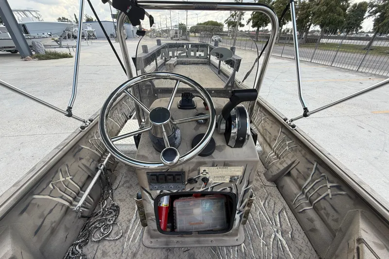 Slide: The Image of Interior view of 2016 SeaArk 180 Mudrunner boat with steering wheel and controls. - 11