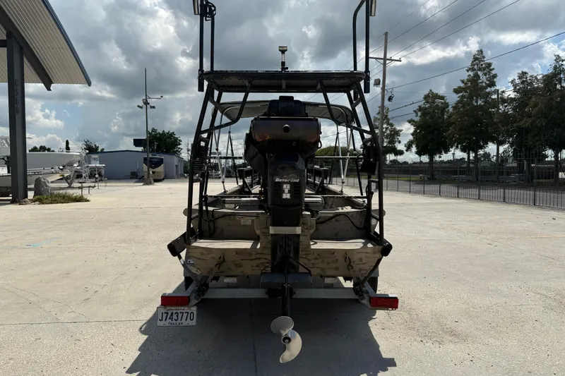 Slide: The Image of 2016 SeaArk 180 Mudrunner boat on trailer, rear view, parked outdoors. - 5