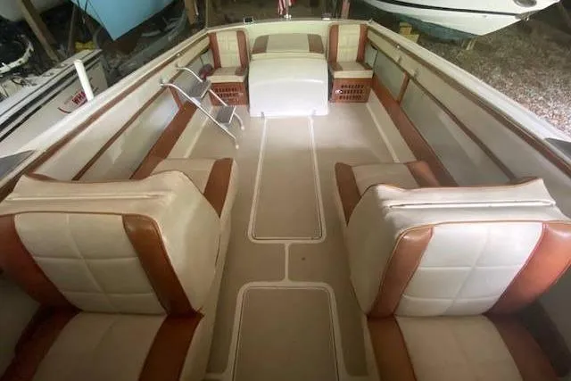 Slide: The Image of 1968 HILINER Sportsman boat interior with beige and brown seating, spacious layout. - 10
