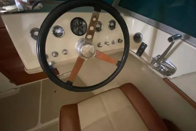 Slide: The Image of 1968 HILINER Sportsman boat dashboard with vintage steering wheel and controls. - 6