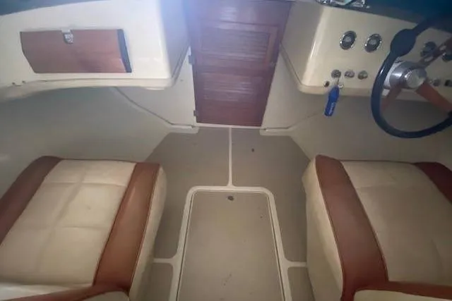 Slide: The Image of 1968 HILINER Sportsman boat interior with beige and brown seating, dashboard, and steering wheel. - 8