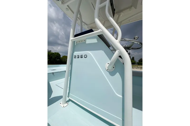 Slide: The Image of 2025 Ranger 2360 Bay boat, light blue exterior, viewed from below with white railing. - 10