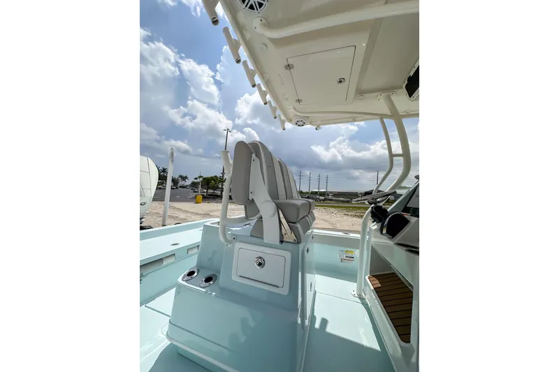 Slide: The Image of 2025 Ranger 2360 Bay boat interior with seating and console under a cloudy sky. - 14
