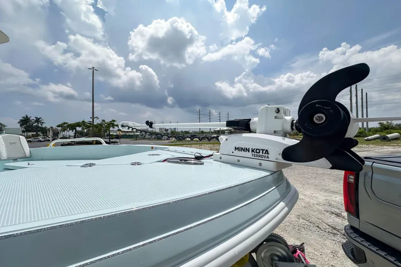 Slide: The Image of 2025 Ranger 2360 Bay boat with Minn Kota Terrova motor under a cloudy sky. - 21