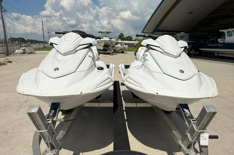 Slide: The Image of Two 2023 Yamaha WaveRunner VX Cruiser HO jet skis on trailers, parked outdoors. - 3
